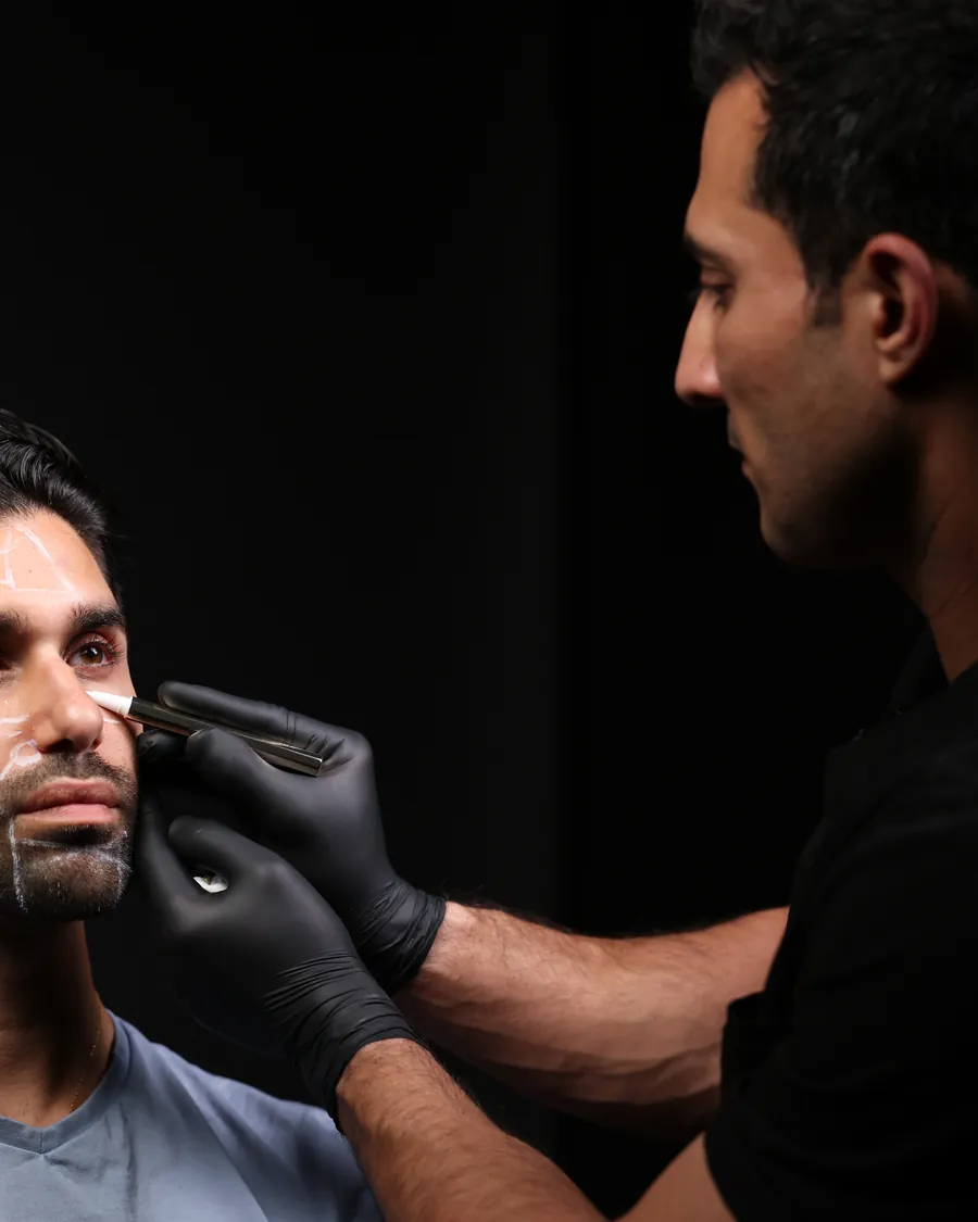 Dr Band placing filler for a male patient in the studio
