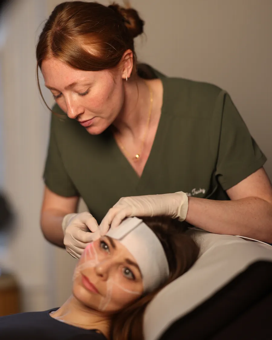 Dr Ellie treating a female patient's brow area