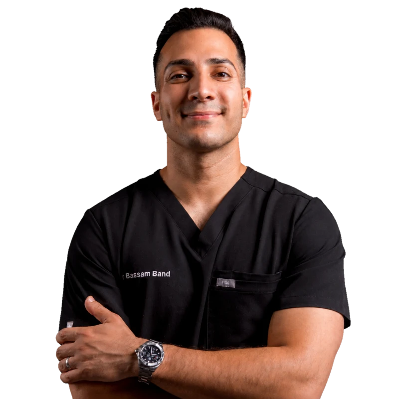Dr Bassam Band, arms folded, in black scrubs